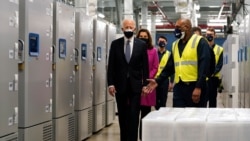 FILE - President Joe Biden walks past freezers used to store Pfizer-BioNtech's COVID-19 vaccine as he tours a Pfizer manufacturing site, Friday, Feb. 19, 2021, in Portage, Mich. (AP Photo/Evan Vucci)