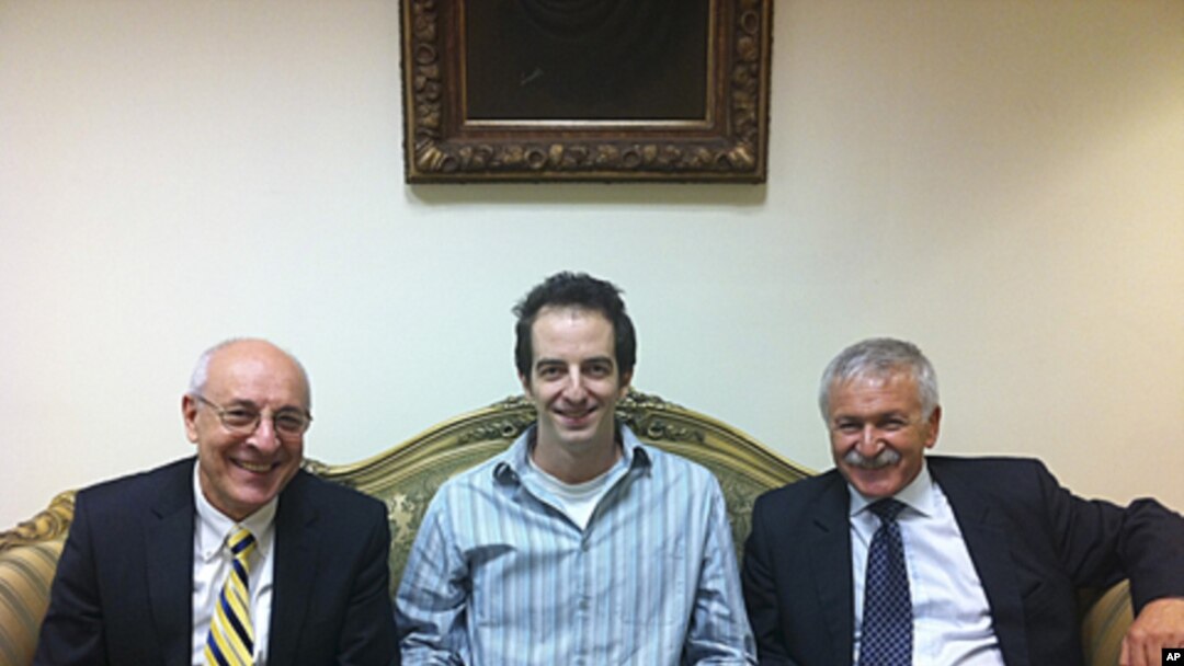 In a photo made available by the office of Israeli Knesset Member Israel Hasson October 26, 2011, shows Ilan Grapel (center), a U.S.-Israeli citizen arrested in Egypt between Israel Hasson, right, and lawyer Yitzhak Molcho, left, in Cairo, Egypt.