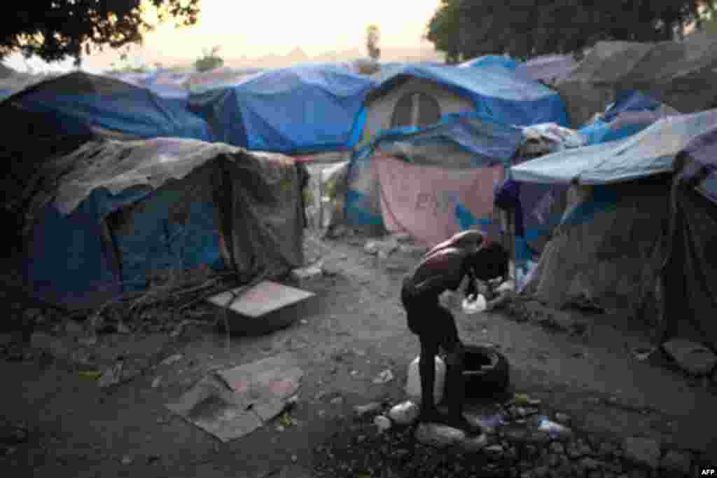 January 25: Aduenel, 44, takes a bath inside a temporary camp for people left homeless from the earthquake in Port-au-Prince, Haiti. Just over a year since the devastating earthquake more then 800,000 Haitians still live in displaced persons' camps. (AP/R