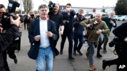 Independent candidate Gerard Hutch runs away from the media after arriving at the RDS, the Royal Dublin Society counting center, as the election count continues in Ireland's election in Dublin, Dec. 1, 2024