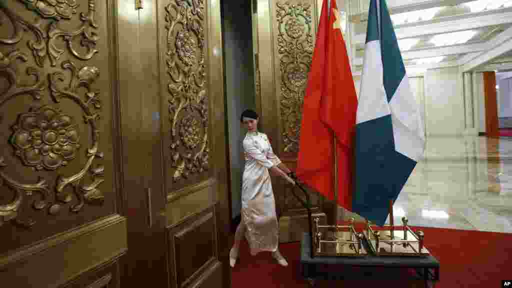 A woman carries flags of China and Nigeria after a welcome ceremony for President Jonathan at the Great Hall of the People in Beijing.