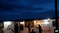 People stand around the Little A'Le'Inn during an event inspired by the "Storm Area 51" internet hoax, Sept. 19, 2019, in Rachel, Nevada. Hundreds have arrived in the desert after a Facebook post invited people to "see them aliens."