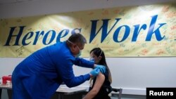 FILE - Healthcare workers get vaccinated at the Trinitas Regional Medical Center in Elizabeth, New Jersey, Jan. 8, 2021. 