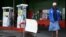 A woman walks past a "No Petrol" sign at a fuel station in Harare, Zimbabwe, Oct. 9, 2018. 