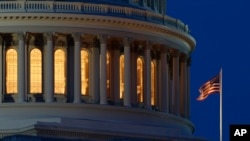 FILE - An American flag flies on the Capitol building in Washington, July 16, 2019. 