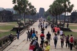 FILE - Tourists visit the Angkor Wat temple in Siem Reap, Cambodia, March 14, 2018. Cambodia's main tourist destination, Angkor Wat, was built between the 9th and 15th centuries.