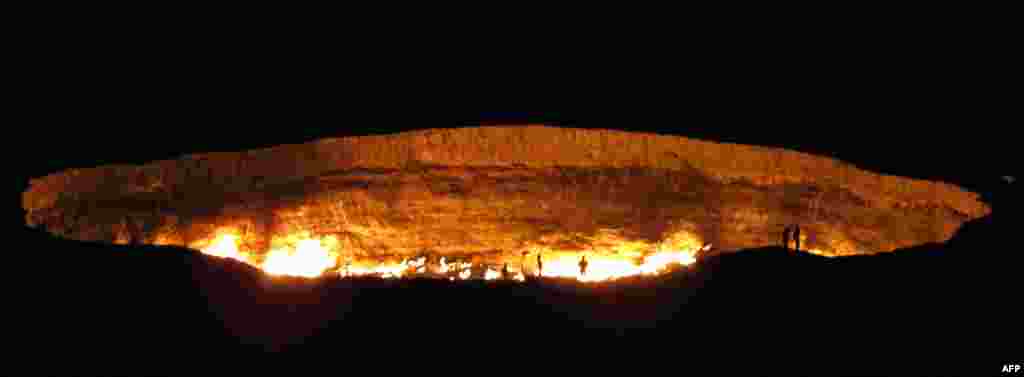 People visit &quot;The Gateway to Hell,&quot; a huge burning gas crater in the heart of Turkmenistan&#39;s Karakum desert. The fiery pit was the result of a simple miscalculation by Soviet scientists in 1971 after their boring equipment suddenly drilled through into an underground cavern and a deep sinkhole formed. Fearing that the crater would emit poisonous gases, the scientists took the decision to set it alight, thinking that the gas would burn out quickly and this would cause the flames to go out. But the flames have not gone out in more than 40 years, in a potent symbol of the vast gas reserves of Turkmenistan, which are believed to be the fourth largest in the world.