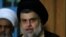 FILE - Iraqi Shi'ite cleric Moqtada al-Sadr speaks during a news conference with Leader of the Conquest Coalition and the Iran-backed Shi'ite militia Badr Organisation Hadi al-Amiri, in Najaf, June 12, 2018.