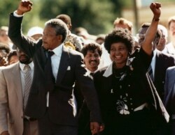 FILE - A 1990 photo showing Nelson Mandela and his then wife Winnie walking upon his release from Victor prison, Cape Town, South Africa.