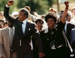 FILE - A 1990 photo showing Nelson Mandela and his then wife Winnie walking upon his release from Victor prison, Cape Town, South Africa.