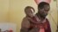 Abdulle Ibrahim, holds his son Adam Ibrahim at the International Rescue Committee, IRC, clinic in the town of Dadaab, Kenya, July 29, 2011.