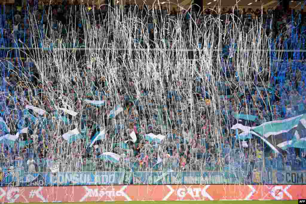 Brazil's Gremio supporters cheer their team before the start of the Copa Libertadores 2018 football match against Argentina's River plate held at the Arena do Gremio stadium, in Porto Alegre, Brazil, Oct. 30, 2018.