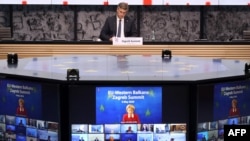 FILE - Croatian Prime Minister Andrej Plenkovic, center, takes part in a video conference with President of the European Commission Ursula Von der Leyen, on screen, and heads of state of EU members in Zagreb, May 6, 2020.