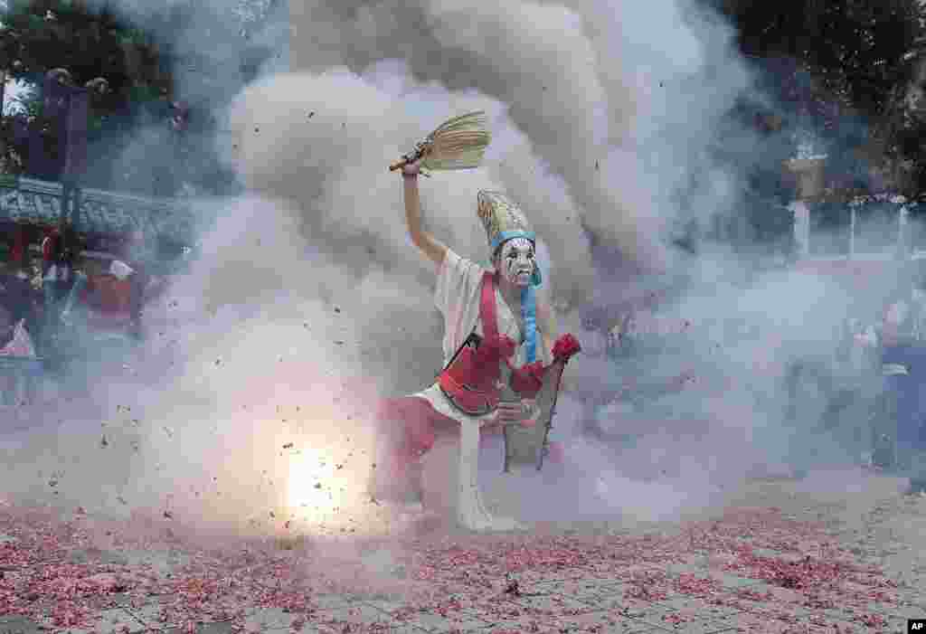 A participant dressed as Ba Jia Jiang, a Chinese guardian of the gods, is purified by firecrackers during a temple festival marking the birthday of traditional Taoist deity &quot;Qingshan Wang&quot; or &quot;Ling&#39;&#39;an Zunwang&quot; in Taipei, Taiwan.&nbsp;(AP Photo/Chiang Ying-ying)