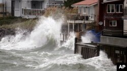 Wind-blown waves batter houses in Seattle, Washington, Nov. 17, 2015.