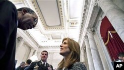 Peace Corps Director Aaron Williams (L) talks with Caroline Kennedy at the reception following a ceremony marking the 50th anniversary of President John F. Kennedy's inaugural address about the Peace Corps, on Capitol Hill in Washington, DC, January 20, 2