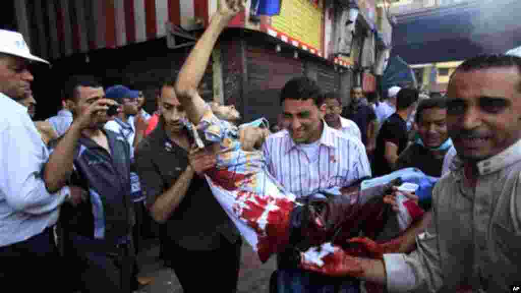 Egyptians evacuate a wounded man during clashes between security forces and supporters of Egypt's ousted President Morsi, Aug. 16, 2013.