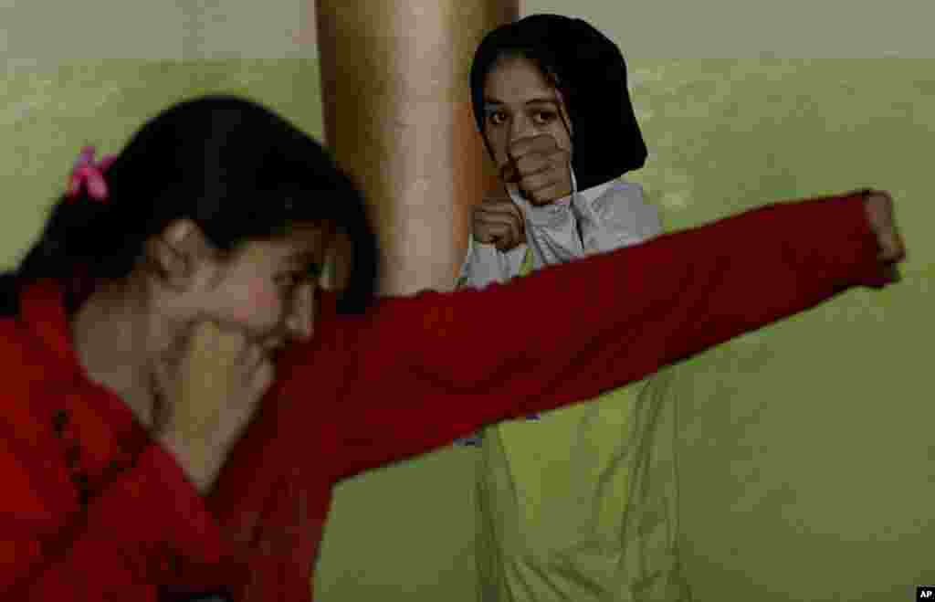 Afghan girls training to be boxers practice at the gym at Ghazi stadium in Kabul, Afghanistan, Oct. 23, 2007. The stadium is where the Taliban used to hold public executions in the late 1990s. This new generation is challenging the stereotype of Afghan wo