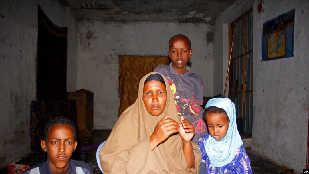 Fatuma Moallim Abdulle is pictured with three of her children in Mogadishu, Somalia, Jan, 18, 2021. She has heard that her son Ahmed Ibrahim Jumaleh, 20, is one of the soldiers sent to Eritrea for training to fight in Ethiopia's Tigray conflict.