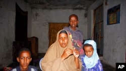 Fatuma Moallim Abdulle is pictured with three of her children in Mogadishu, Somalia, Jan, 18, 2021. She has heard that her son Ahmed Ibrahim Jumaleh, 20, is one of the soldiers sent to Eritrea for training to fight in Ethiopia's Tigray conflict.