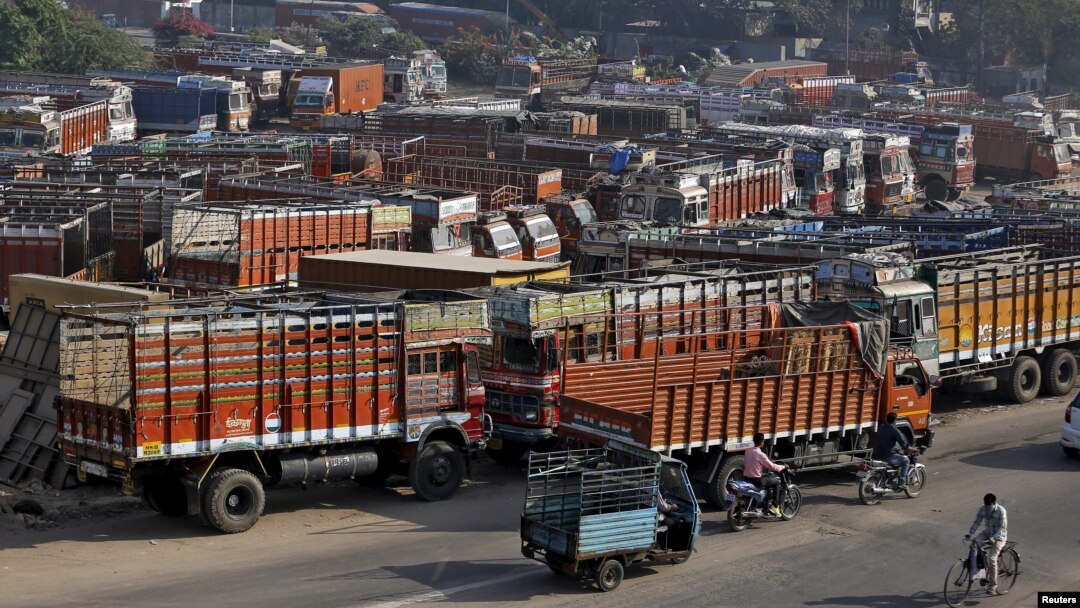 Trucks are seen parked in an open lot near a national highway on the outskirts of Ahmedabad, India, Dec. 2, 2015.