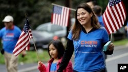 FILE - Christine Lui Chen, right, who is running for state senate during the November elections, walks with her daughter Lily Chen, 6, while participating in the Bridgewater Memorial Day Parade in Bridgewater, N.J., May 29, 2017.