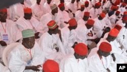 FILE - In this photo taken on Thursday, Dec. 19, 2013. Nigerian Muslim men attend a mass wedding in Kano, Nigeria.