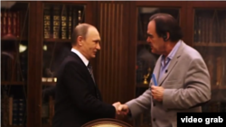 A view grab from 2017's "The Putin Interviews”, showing U.S. director Oliver Stone shaking hands with Russian President Vladimir Putin. Stone recently interviewed Putin again for his latest film, "Revealing Ukraine".
