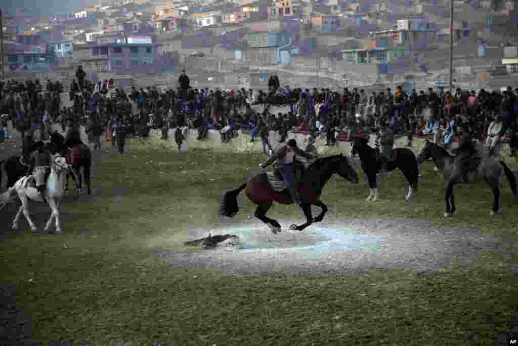Afghan horse riders compete for the goat during a friendly buzkashi match on the outskirts of Kabul, Afghanistan.
