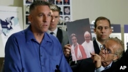 Tom Emens, left, who was sexually abused by a priest, speaks on his experience next to attorney Jeff Anderson, Oct. 2, 2018, in Los Angeles. 