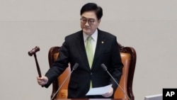 South Korea's National Assembly Speaker Woo Won Shik bangs a gavel during a plenary session for the impeachment motion against South Korean acting President Han Duck-soo at the National Assembly in Seoul, South Korea, Dec. 27, 2024.