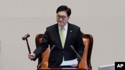 South Korea's National Assembly Speaker Woo Won Shik bangs a gavel during a plenary session for the impeachment motion against South Korean acting President Han Duck-soo at the National Assembly in Seoul, South Korea, Dec. 27, 2024.