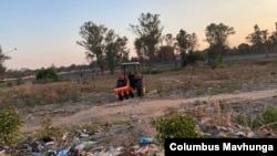 A farmer in Harare with a tractor is about to start tilling his land in preparation for the rain season about to start in Zimbabwe on Nov. 8, 2021.(VOA/Columbus Mavhunga)
