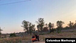 A farmer in Harare with a tractor is about to start tilling his land in preparation for the rain season about to start in Zimbabwe on Nov. 8, 2021.(VOA/Columbus Mavhunga)