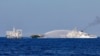 FILE - Chinese Coast Guard vessels fire water cannons towards a Philippine resupply vessel Unaizah May 4 on its way to a resupply mission at Second Thomas Shoal in the South China Sea, March 5, 2024.