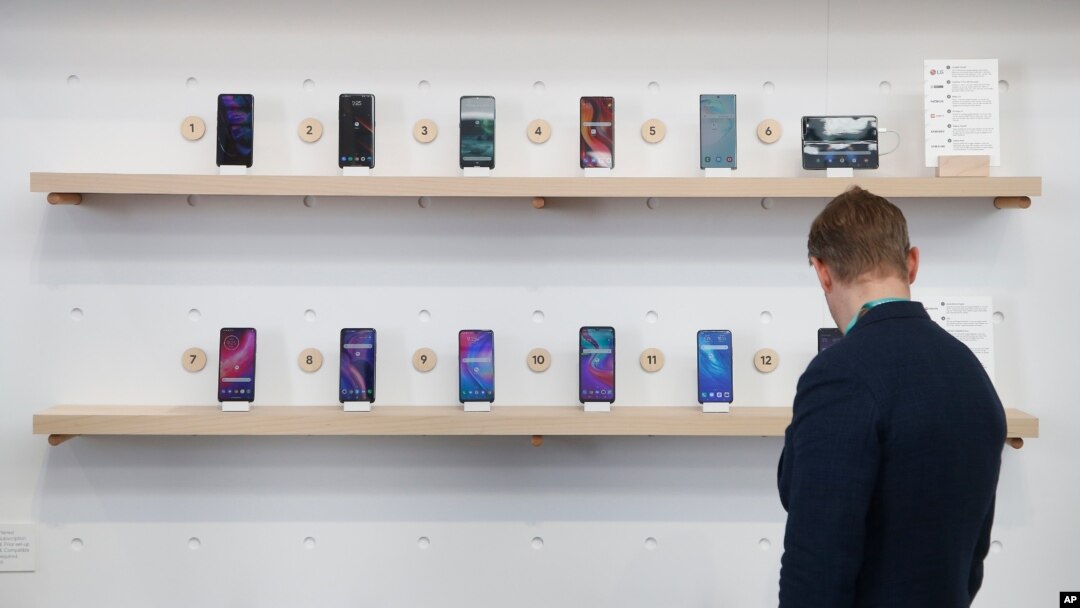 FILE - The Google exhibit building shows off a variety of devices with Google Assistant, including Android smartphones and Wear OS smartwatches during the CES tech show in Las Vegas, Jan. 8, 2020.