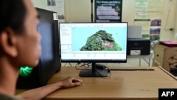 FILE - This picture taken on November 22, 2023 shows Chiang Mai University's Forest Restoration Research Unit field research officer Worayut Takaew creating a 3D model of overlapping images taken from his drone at his lab in Chiang Mai.