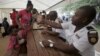 Refugees fleeing anti-immigrant violence are processed by immigration officers at a transit camp in Beit Bridge, ZImbabwe, April 24, 2015.