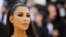 FILE - Kim Kardashian West arrives at the Metropolitan Museum of Art Costume Institute Gala (Met Gala) to celebrate the opening of “Heavenly Bodies: Fashion and the Catholic Imagination” in the Manhattan borough of New York, U.S., May 7, 2018. 
