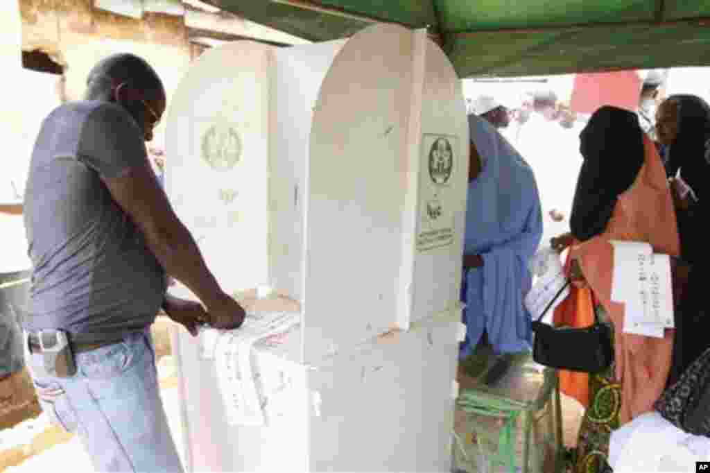 People thump print ballot papers during gubernatorial election in Kaduna, Nigeria, Thursday, April 28, 2011. Two states in Nigeria's Muslim north voted Thursday for state gubernatorial candidates after their polls were delayed by violence that killed at