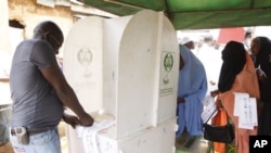 People thump print ballot papers during gubernatorial election in Kaduna, Nigeria, Thursday, April 28, 2011. Two states in Nigeria's Muslim north voted Thursday for state gubernatorial candidates after their polls were delayed by violence that killed at