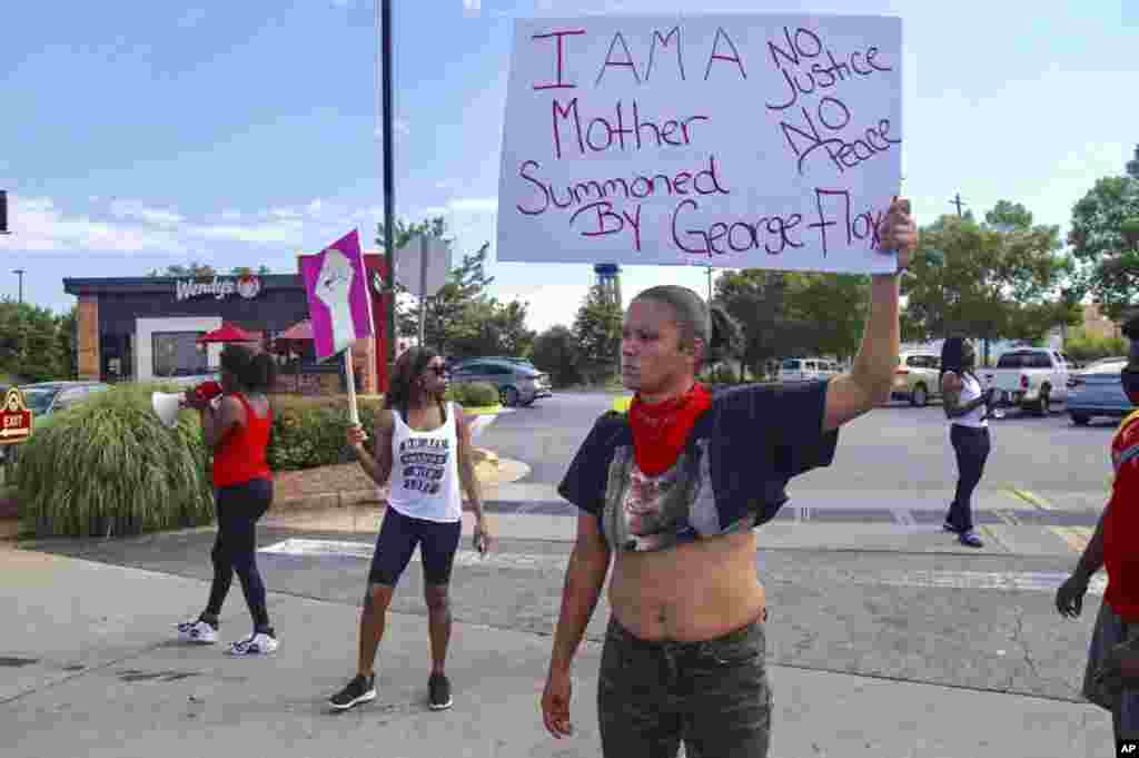 Protestors gather outside the Wendy&#39;s fast food restaurant in Atlanta on Saturday, June 13, 2020, where Rayshard Brooks, a 27-year-old black man, was shot and killed by Atlanta police Friday evening during a struggle in a drive-thru line. (Steve Schaefer/