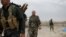 FILE - Kurdish Peshmerga fighters search for Islamic State militants in Telskuf, northern Iraq, May 4, 2016.