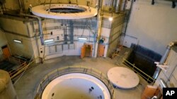 FILE - In this photo released by the Atomic Energy Organization of Iran, technicians work on the Arak heavy water reactor's secondary circuit, near Arak, 150 miles (250 kilometers) southwest of the capital Tehran, Iran, Dec. 23, 2019. 