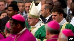 Pope Francis arrives to celebrate the opening Mass of the Synod of bishops, in St. Peter's Basilica at the Vatican, Oct. 4, 2015. 