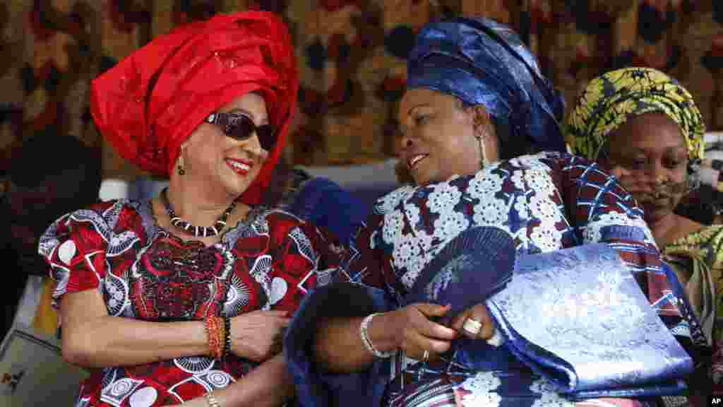 Trinidad and Tobago Prime Minister Persad-Bissessar  talks with First Lady Patience Jonathan during Emancipation Day celebrations, August 2012.