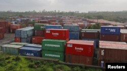 FILE - Cargo containers are seen stacked outside the container terminal of Jawaharlal Nehru Port Trust (JNPT) in Mumbai, India.