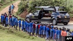 Students line up next to the road to see the vehicle carrying the coffin of late marathon runner Kelvin Kiptum during his funeral in the village of Chepkorio. Kenya's world-record holding marathon runner, who ran three of the seven fastest marathons in history and was ranked first among the world's men's marathon runners, died in a car crash in Kenya on Feb. 11, 2024, at the age of 24.