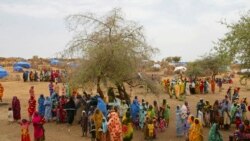 FILE - In this Thursday, July 1, 2004 file photo, Sudanese displaced women gather at the Zam Zam refugee camp just outside the town of El-Fashir in the Darfour region of Sudan, during a visit by U.N. Secretary General Kofi Annan