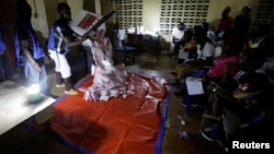 FILE - Polling agents start to count the ballots for the Liberian presidential election at a polling station in Monrovia, Liberia, Oct. 10, 2017. 